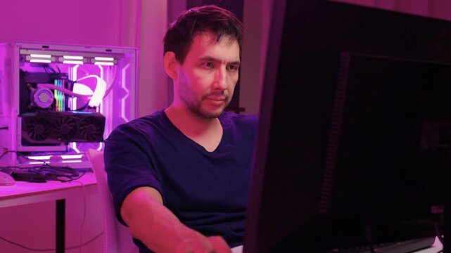Solo software engineer working through technical issues late at night. Dedicated coder in dim lighting diagnosing problems on open computer case with intense concentration