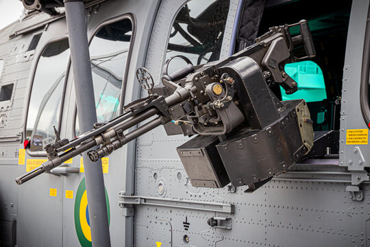 Military helicopter equipped with a machine gun mounted at the side window. 