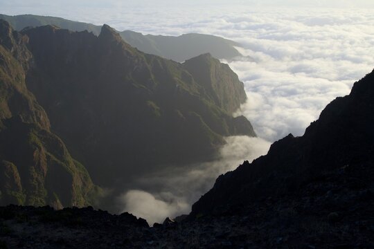 Deep mountain valley filled with rolling clouds