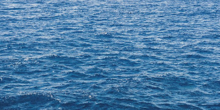 Calm ocean waves with gentle ripples for serene background design