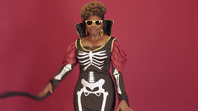 African american woman in skeleton costume dancing for halloween