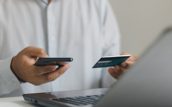 Businessman shopping online with credit card and smartphone using buy now pay later service, representing flexible payment options, digital finance, and modern e-commerce checkout experience.