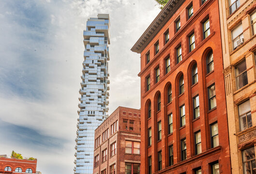 56 Leonard Street rises above historic brick buildings in Tribeca.