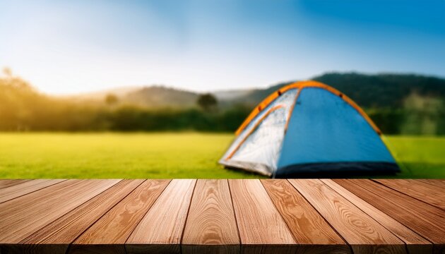 wooden table in blur camping tent and grass field cool and relaxing concept for product display montage or key visual layout design space for text