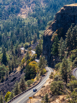 Iconic horseshoe bend on the Historic Columbia River Highway at Rowena Crest, winding through dry forested hills in Oregon