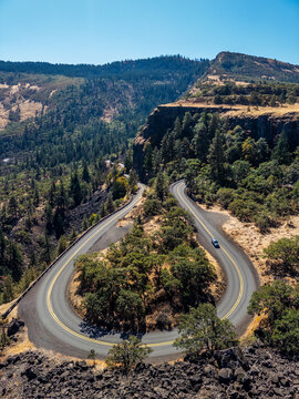Iconic horseshoe bend on the Historic Columbia River Highway at Rowena Crest, winding through dry forested hills in Oregon