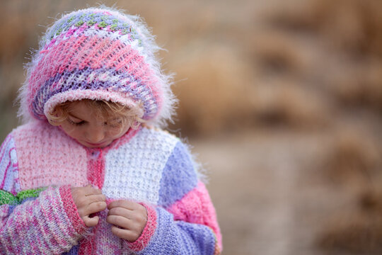 Young Child in Colorful Winter Sweater With Copy Space