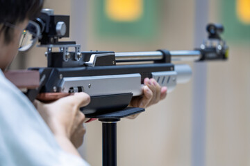Athlete holding air rifle focus on aiming shooting training © Dong