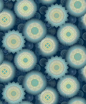 Seamless intricate mandala rosette pattern with pale blue ivory and turquoise motifs on deep navy blue background