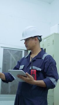 Environment Engineers checking data electrical control panels, air pollution reduction on digital displays.Technician use tablet continuous emission monitoring system in factory and industry. ESG. Eco