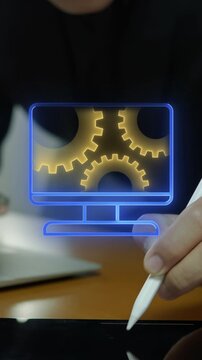 Businessman hand holding stylus pen beside laptop vertical shot with glowing screen and dual gears. Corporate business operations management, organizational teamwork workflow, and project concept.