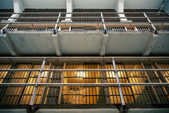 View looking up at the interior ceiling and cell blocks of a historic prison