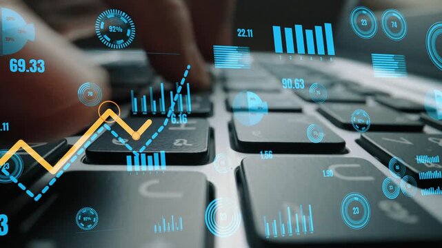 Close view of hands typing on a laptop keyboard with digital graphs and data visualization appearing above, illustrating modern business analytics and technology usage. Xenic