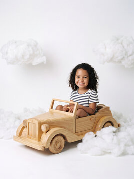 Creative young child playing with cardboard toy and pretending to live an adventure
