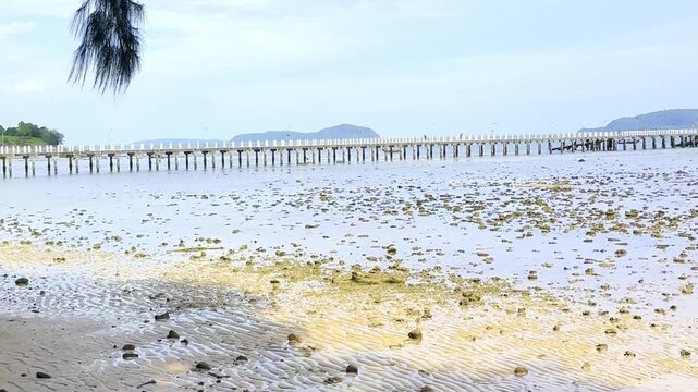Beautiful and colourful Seascape of Ra Wai Rawai Beach with white sandy beach, Rocky Shoreline and Tropical Forest, on the island of Phuket, Thailand