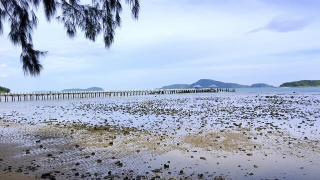 Beautiful and colourful Seascape of Ra Wai Rawai Beach with white sandy beach, Rocky Shoreline and Tropical Forest, on the island of Phuket, Thailand