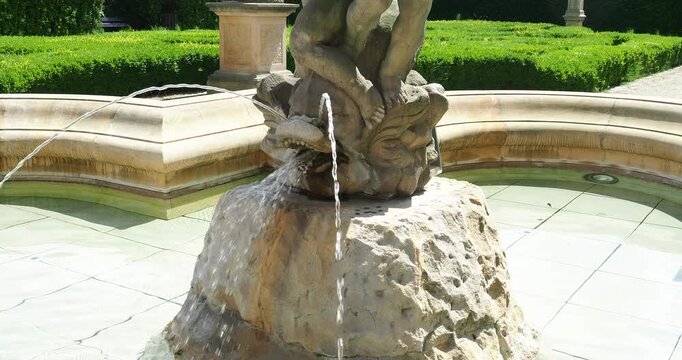 Close-up of a historical stone fountain with splashing water in the baroque garden of the Royal Palace in Wroclaw, Poland