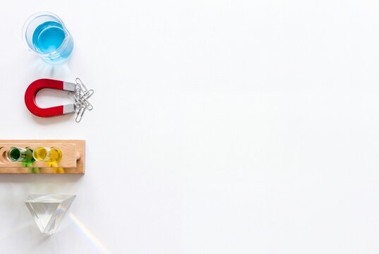 Science beaker magnet test tubes and prism on white background