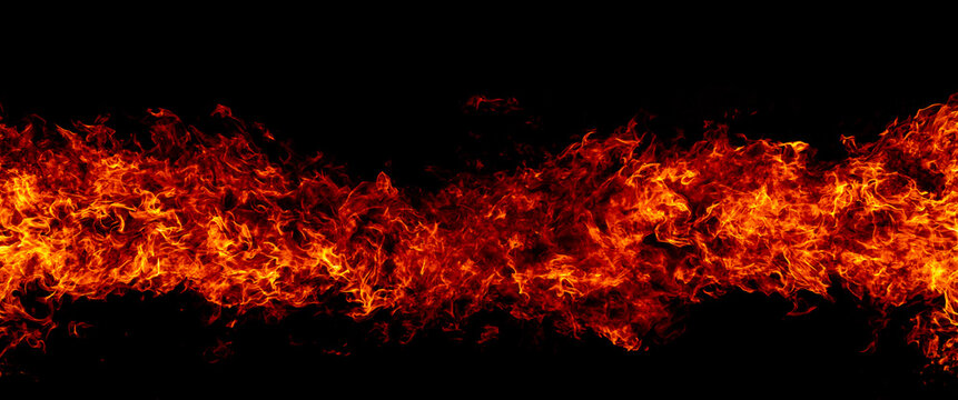 Effect of blazing flames. Glowing fire effect on black. Effect of swirling fire. Horizontal flame effect with copy space.