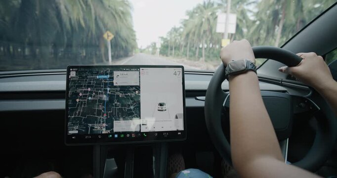 Women drive EV car use navigator GPS travel in nature village transport technology