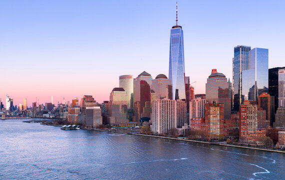 NYC landscape at sunset. New York City panoramic skyline at sunset. New York aerial view of Manhattan skyscrapers. NYC skyline with Hudson landscape at sunset.