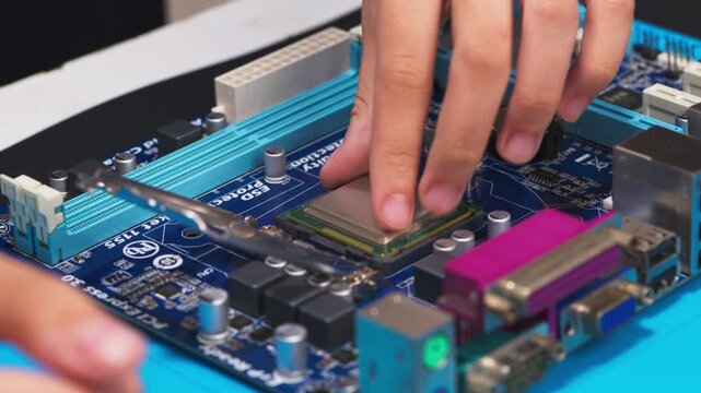 hand installing a central processing unit CPU microprocessor chip into computer motherboard socket as a conceptual metaphor for AI hardware technology computer engineering data 