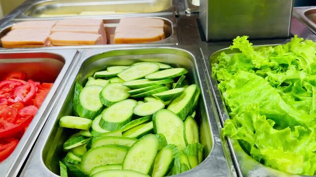 Fresh sliced cucumbers and green lettuce salad on all inclusive hotel buffet. Organic vegetables and cheese cubes bar at luxury Sharm El Sheikh resort five stars restaurant catering. Food video.
