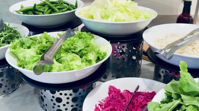 Fresh green lettuce leaves and shredded cabbage at all inclusive resort hotel buffet counter. Healthy salad bar selection inside five stars restaurant dining area background, cold food photo!!
