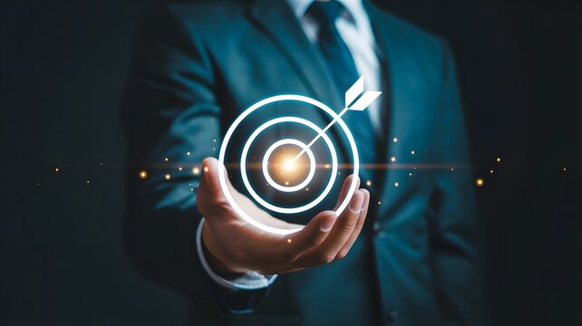 A professional business photo of a person holding a glowing digital target icon representing strategic goals and corporate success