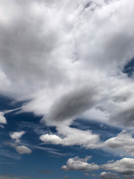 Layered White Clouds Against Deep Blue Summer Sky