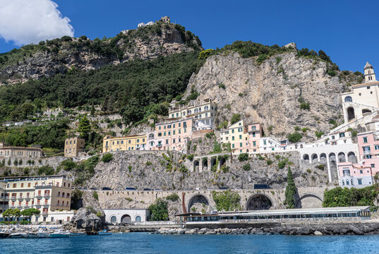 Facades of famous town of Amalfi, located on the Amalfi Coast, with its azure sea and beautiful colorful cliffside houses.