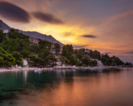 Croatia, Dalmatia, the Adriatic coast at sunrise, with the Biokovo Mountains and forests in the background. The village of Brela is a summer resort on the Makarska Riviera.