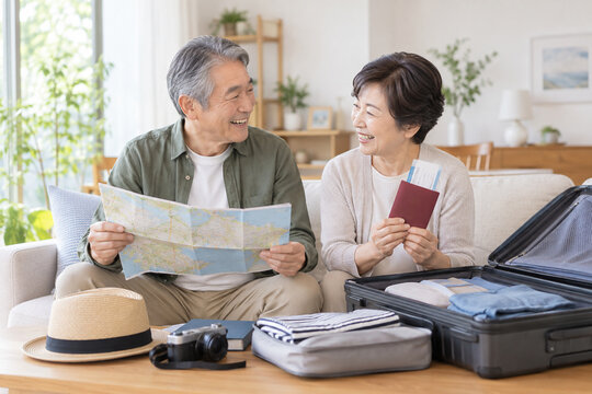 Japanese senior couple preparing for a trip at home