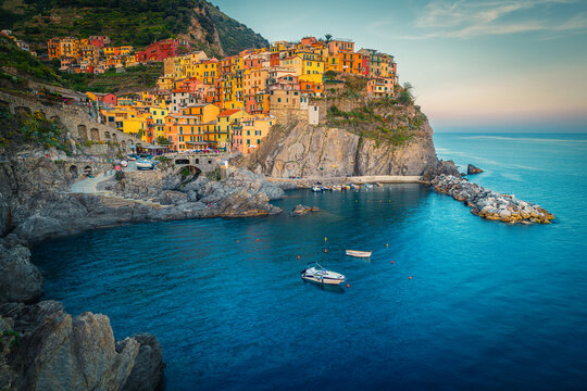Manarola with colorful seaside houses on the cliffs at sunset