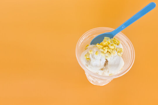 Thai coconut ice cream in a cup on orange background
