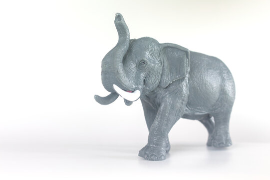 Toy elephant figurine raising trunk with copy space