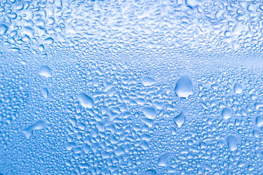 Dense water droplets on blue surface selective focus macro