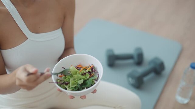 Healthy Asian Woman Enjoying Fresh Salad at Home After Yoga Workout