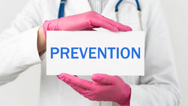 Doctor in pink gloves holding prevention sign photo illustration