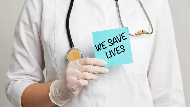 Doctor in medical uniform holding sticky note with we save lives message photo illustration