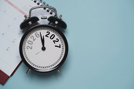 2027 New Year countdown concept with black vintage alarm clock and calendar on blue background symbolize business year transition for annual planning, upcoming deadlines, time management.