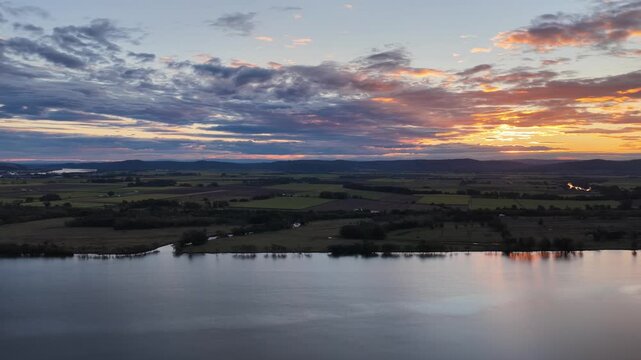 Aerial footage of the Clarence River and farmland in the warm evening light on Palmers Island, Yamba, New South Wales.