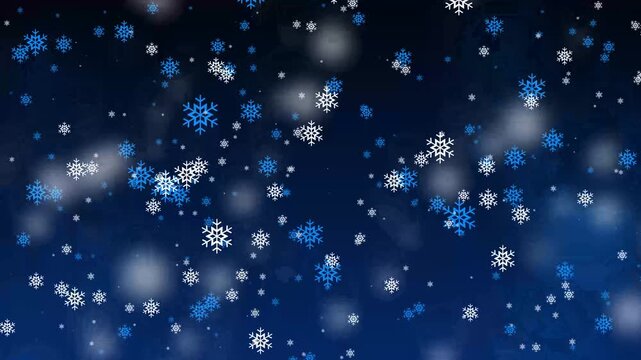 Snowflakes drift gently against a deep blue night sky. White and blue flakes fall softly, creating a peaceful winter scene. Blurred lights add warmth and depth to the snowy backdrop