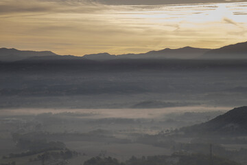 Fog filling valley with mountains at twilight © Valenti
