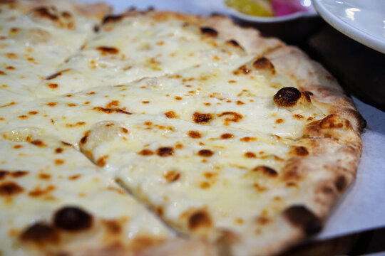 Crispy thin crust gorgonzola cheese pizza served with sweet honey