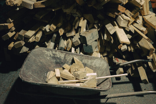 A pile of wooden beams next to the cart, preparing firewood