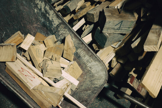A pile of wooden beams next to the cart, preparing firewood