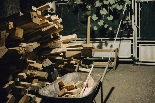 A pile of wooden beams next to the cart, preparing firewood