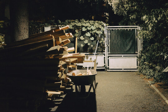 A pile of wooden beams next to the cart, preparing firewood