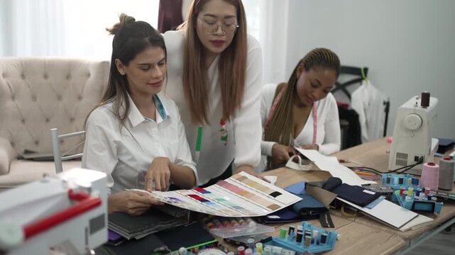 Seamstresses Cutting Fabric in Small Business Tailor Shop